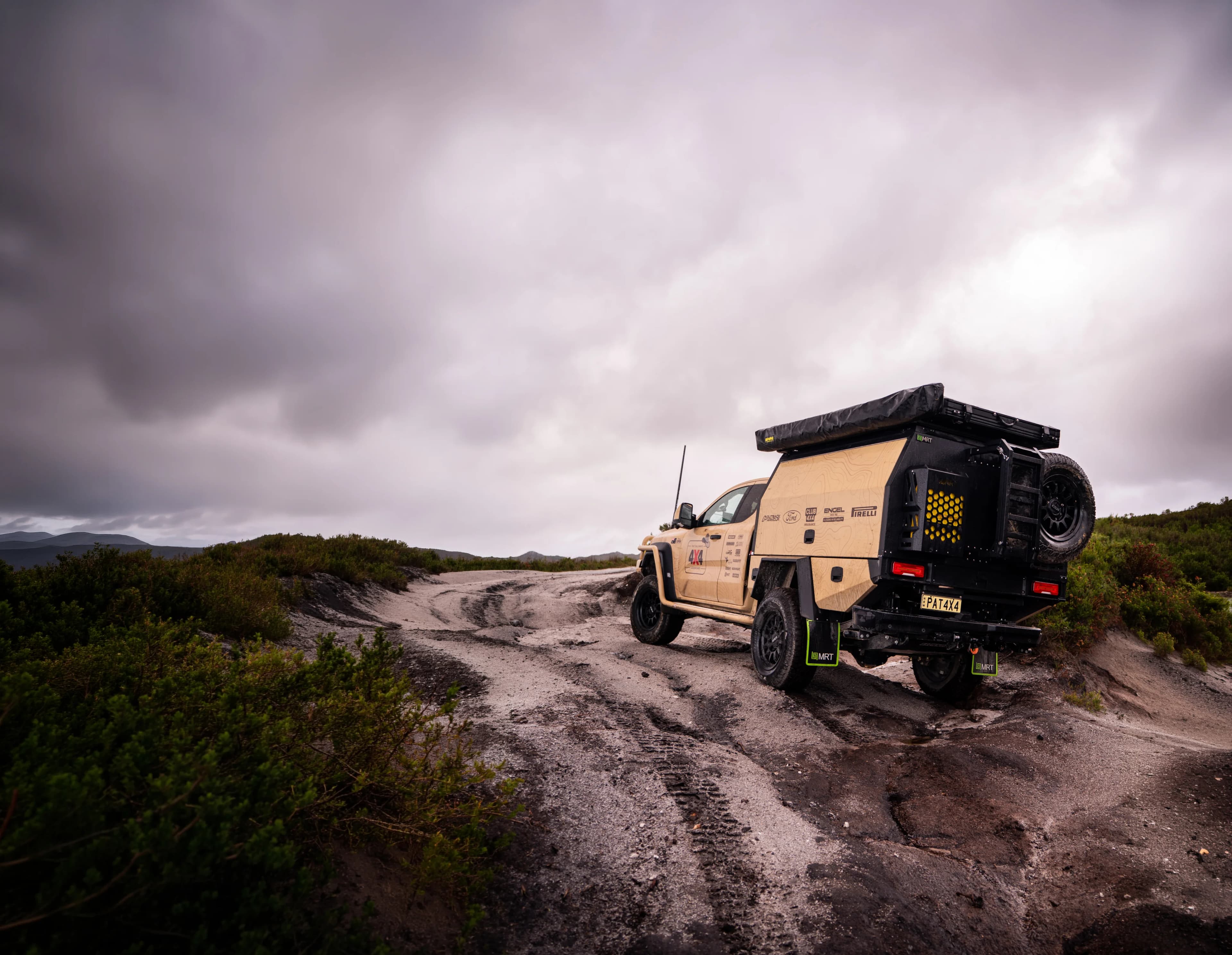 MRT canopy-fitted 4x4 towing a camper trailer on a remote outback dirt road