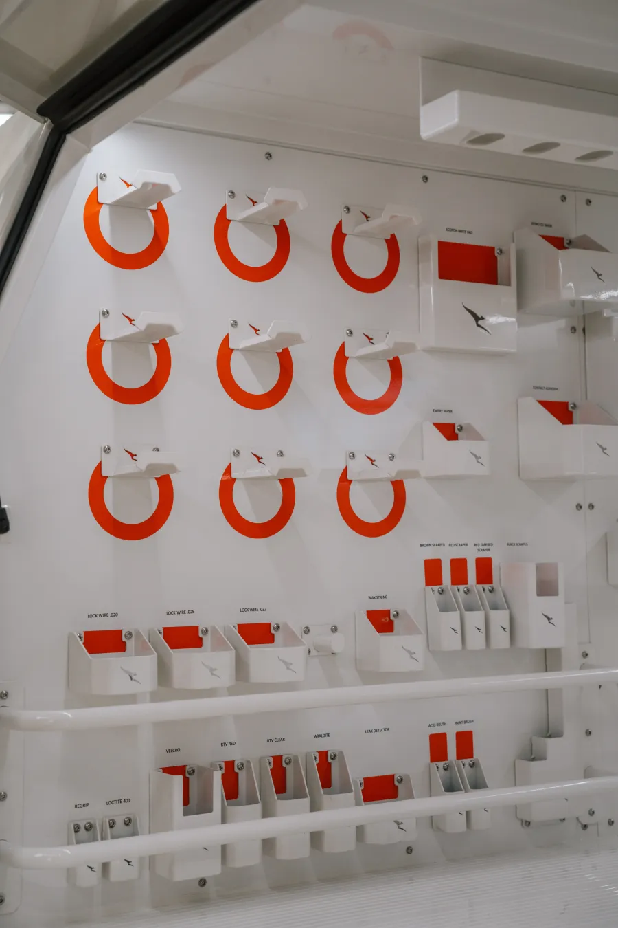 Wall-mounted, labelled tool storage system inside the MRT manufacturing facility