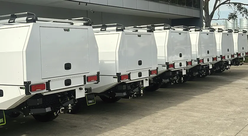 Fleet of Ford Ranger utes fitted with matching MRT canopies, parked in a row outside an MRT facility